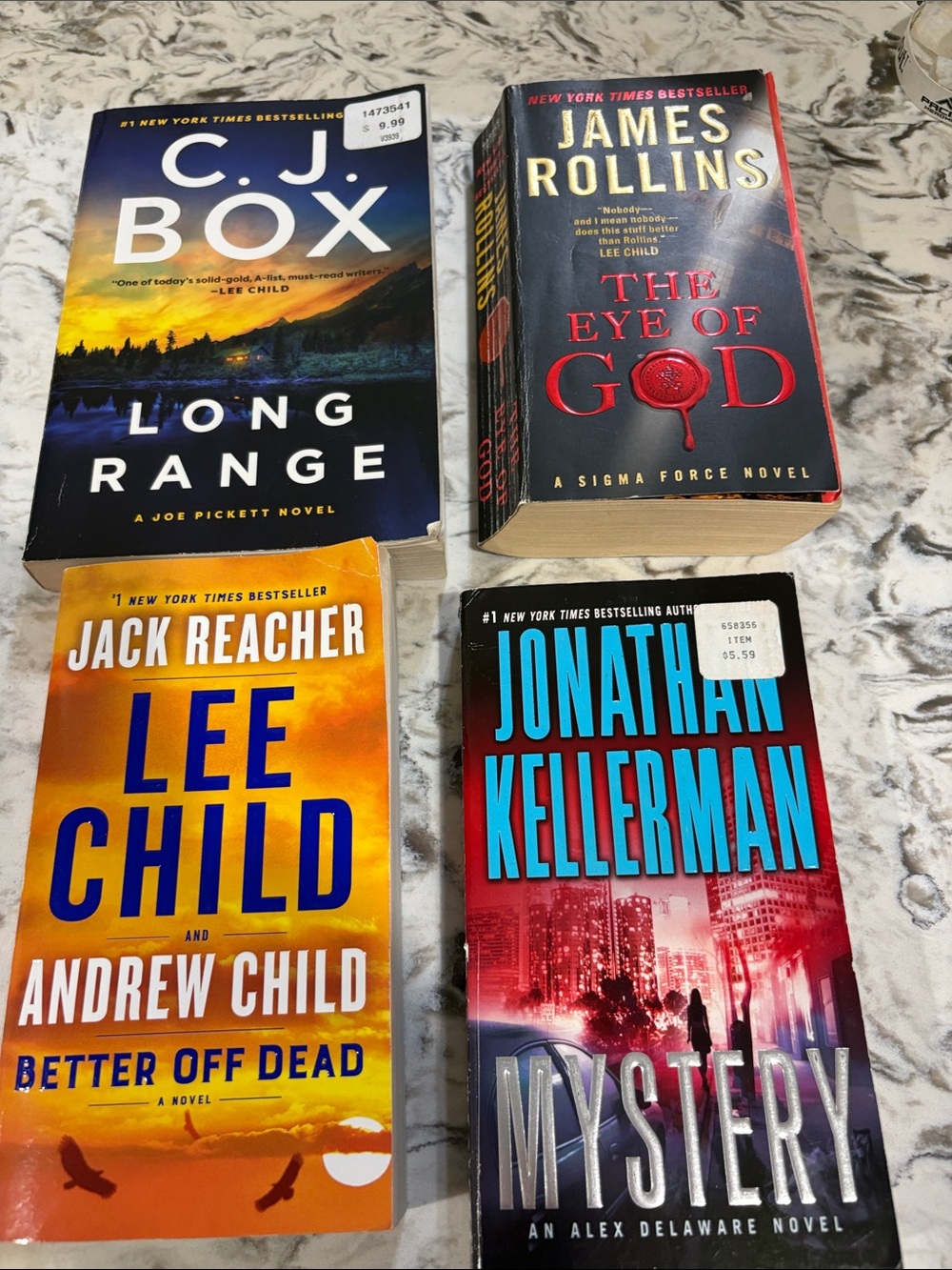 4 Assorted Paperback Thriller Books - Black, Red, Yellow, Blue